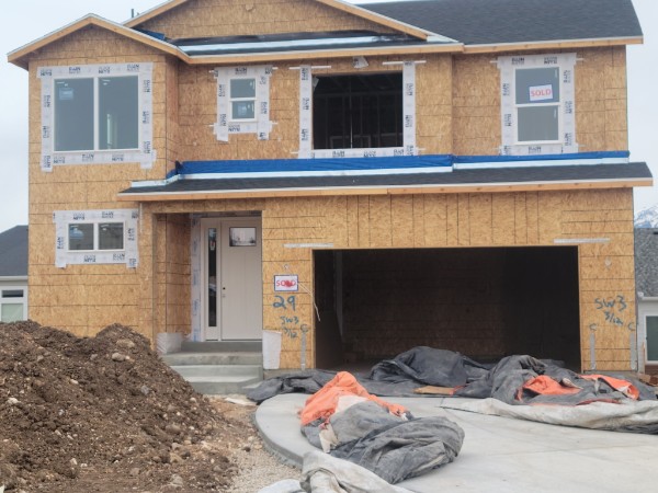 Two-story sheathed frontage with two upper gables and garage.