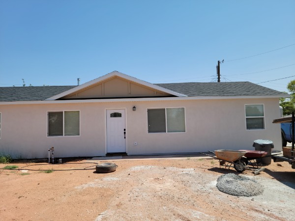 White stucco single-story frontage with small center gable.